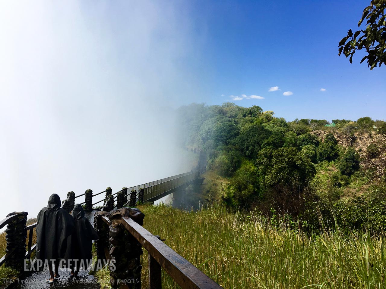You will get wet! The spray from Victoria Falls engulfs the Knife's Edge Bridge. Victoria Falls, Livingstone, Zambia. 