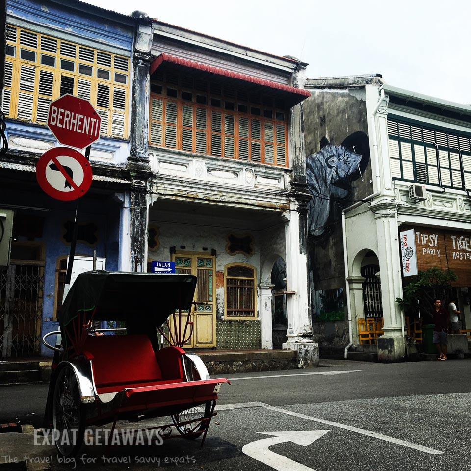 The old and the new in the George Town, Penang. UNESCO listed houses, rickshaws and modern street art. 