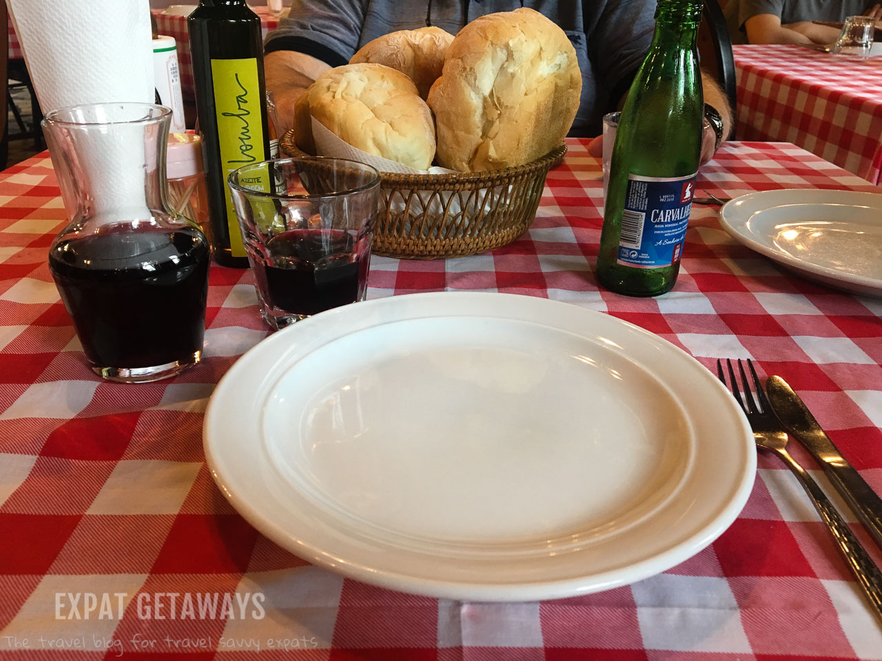The wine in a tumbler and the simple red checked tablecloth set the scene for a delicious Portuguese lunch at Fernando's in Macau. 