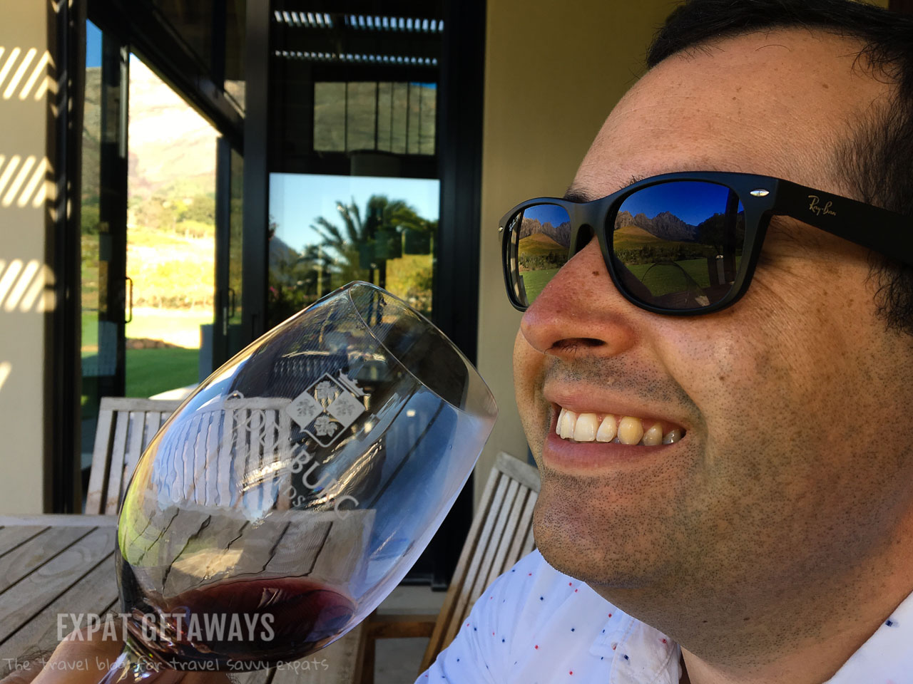 Andrew enjoying a glass of red wine in the Franschhoek wine region just outsite of Cape Town. Expat Getaways One Week in Cape Town, South Africa. 
