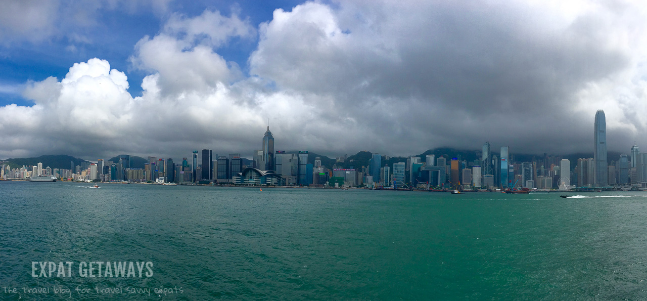 Dark clouds roll in over the Hong Kong skyline. Hong Kong weather in summer is unpredictable at best. Expat Getaways, First Time Hong Kong Survival Guide - Weather and Seasons. 