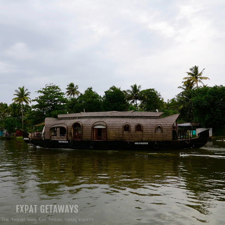 A houseboat cruises along the Kerala Backwaters near Alleppey. Expat Getaways - One Week in Kerala, India.