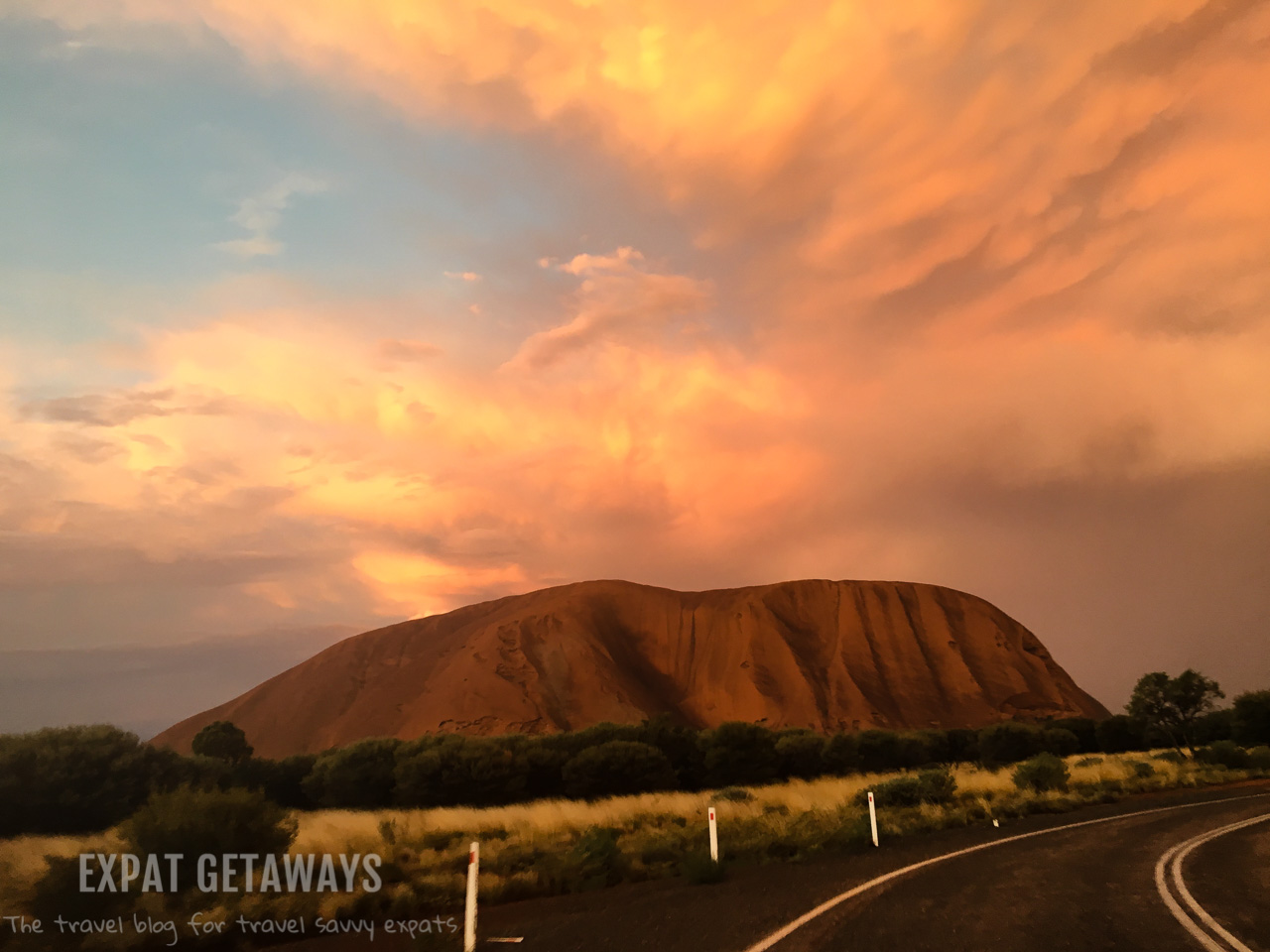 Uluru is amazing at sunset, especially after a storm. Expat Getaways - Babymoon Destinations.